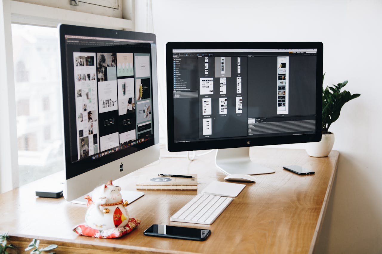 pexels-tranmautritam-326503 Two Imac's With Keyboard and Phones on Desk